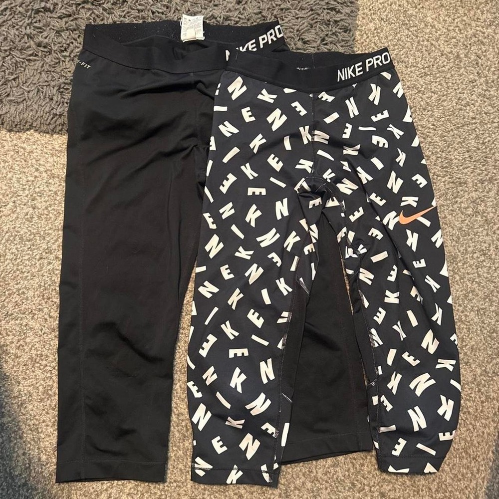Nike Pro black leggings 2 pairs one solid black other with white logo pattern